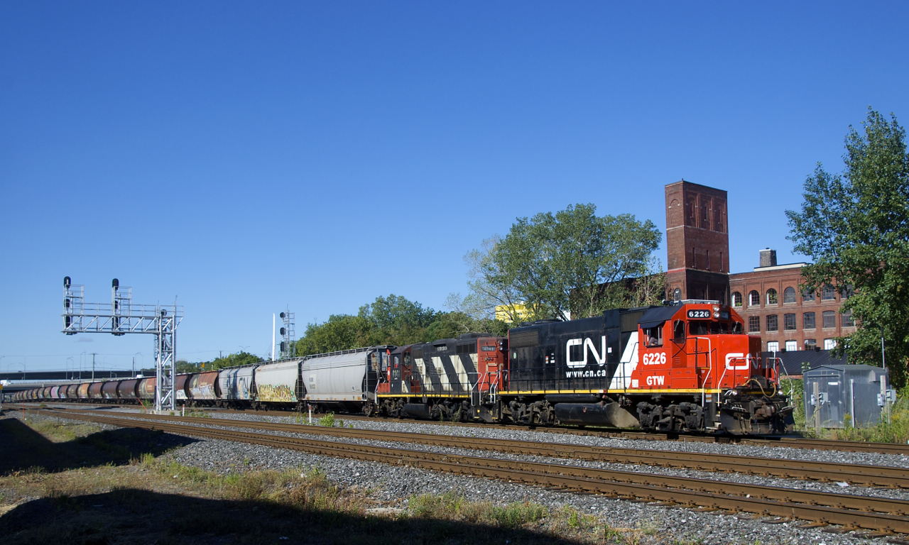 The Pointe St-Charles Switcher is pulling 21 grain loads from track 29 with GTW 6226 & CN 4141 for power . The grain cars are destined for track PC-27 (Five Roses Flour). Eighteen of the cars are MGLX cars.