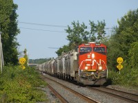 Grain train CN 874 is approaching Dorval Station the morning after the Kingston Sub was reopened after a collision at Prescott closed it for about 36 hours.