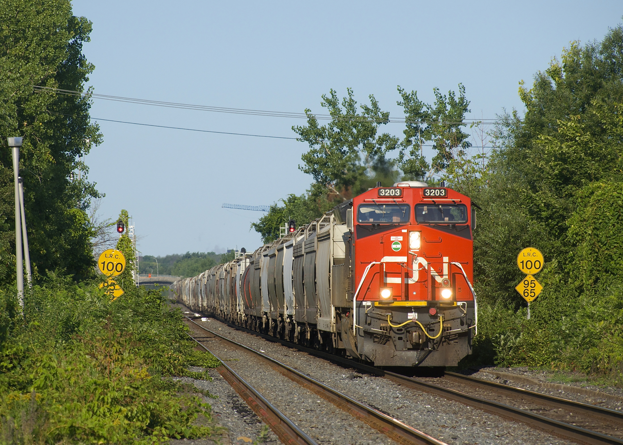 Grain train CN 874 is approaching Dorval Station the morning after the Kingston Sub was reopened after a collision at Prescott closed it for about 36 hours.