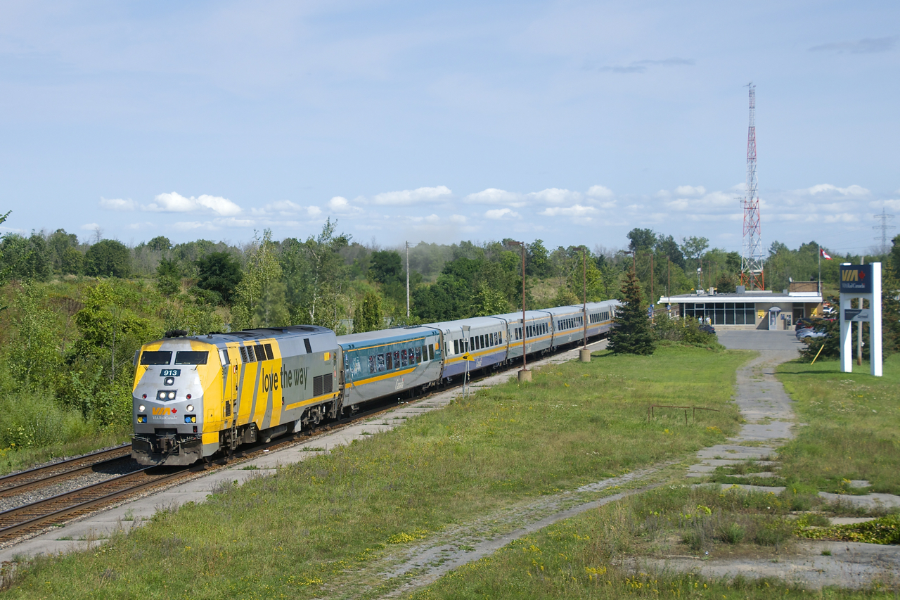 VIA 67 is departing Cornwall Station with VIA 913 and six LRC cars.