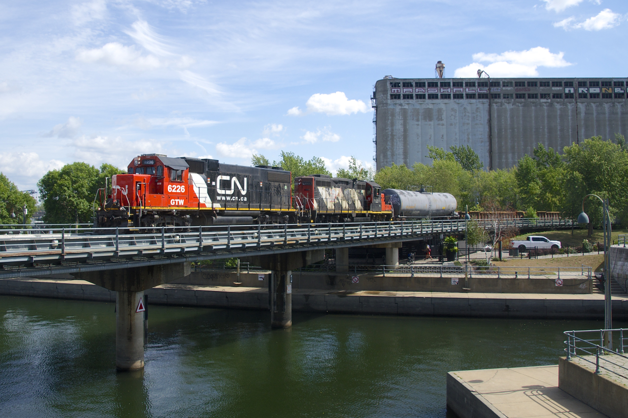 An ex-DTI unit now wearing CN paint (GTW 6226) leads CN 4141 as they enter the Port of Montreal with a transfer.