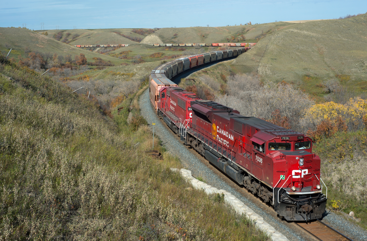 CP 603 is seen grinding it's way up Craven hill toward Regina with "pusher" unit 6300 added behind the 7036 for some extra muscle. A very dry summer has lead to a rather dull week of "fall" colour this year, but it still beats snow!