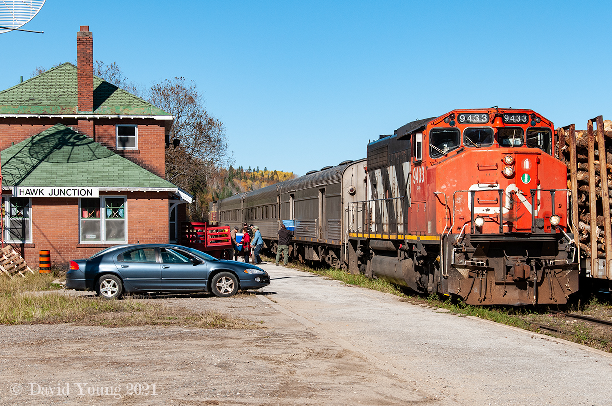 They weren't the best times but they were certainly better than how they are now found along the former Algoma Central in 2021. The southbound passenger, labelled as the "Tour of the Line" train has arrived at Hawk Jct and is taking on a couple passengers while a couple detrain. It's a busy few moments as totes and coolers are unloaded from the baggage car. On the paved platform a number of baggage carts take up real estate, being as inviting and patient as possible for the guests. One may end up being used to rest any waiting bags, fishing or hunting gear.