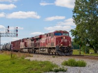 CP 8906 and 9710 (plus DPU 8912) lead #112 through the new plant in Finch, Ontario. Through 2020, the Winchester Subdivision was converted from a directional-double-track, ABS-signalled territory to a CTC-signalled single track with sidings. There used to be a pair of single-searchlight intermediate signals east of the Main Street crossing in Finch. I had hoped to catch a train there before the end of ABS, but that didn't work out. However, the crossing in Finch is still double-tracked, as the former north main here serves as one of the new CTC sidings. The new LED signals are no searchlights, but at least they put them on a cool gantry. Plus a backtrack off the siding retained one of the hand-throw switch targets.

Finch was at one time a junction, where the New York Central line to Ottawa crossed the CP main. The NYC gave up the line in 1957, when their bridge in Cornwall became a casualty of the St. Lawrence Seaway opening. However, before this happened, rail operations in Finch were captured in a <a href"https://www.youtube.com/watch?v=GUznPBD6tSs&t=749s"> National Film Board short.</a>
