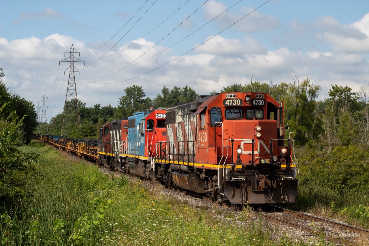 CN L584 heading South on the Talbot Spur with empty auto frames, corn tanks and hoppers to interchange with OSR. Luckily I was fortunate enough to not catch the two GATX's that typically ran this job at the time!
