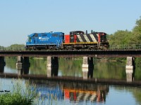 The early Sunday morning calm is briefly interrupted as CN L542 slowly rubbles across the Speed River bridge in the village of Hespeler on the Fergus Spur. CN 1408 and GMTX 2279 were returning to Guelph light-power after setting-off loaded bulkhead cars at Hunts Logistics near Eagle Street as well as Gillies Lumber at Industrial Road in Cambridge.
