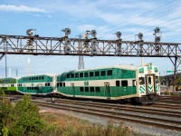 Recently reactivated old cabcar GO 253 leads a westbound Lakeshore East GO train into the Union Station Rail Corridor (USRC) as it rolls slowly towards Union Station.
The most notable part of this shot is the bank of searchlights that GO 253 is passing under. While the actual searchlights date to sometime in the mid 60s or so, the bridge itself is nearly 90 years old, having been built in the 1930s. Other searchlights in the east half of the USRC are quickly getting replaced by LEDs, and this bridge has a concrete slab nearby for its replacements, so I knew I had to get a shot quickly before this piece of history disappears. 