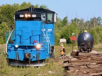 Back in the CP days Snelgrove was the location of a trans-loading facility, with the siding often full of covered hoppers. Once CP rid itself of the Owen Sound sub. the facility was left empty and all translating was moved to Streetsville. The siding did however remain and during the Cando years it was often used as not only a run around location for trains serving the one remaining customer about a mile to the south, but it also served as a turn around spot for the popular Credit Valley Explorer excursion trains. When Cando terminated its contract on the line the passenger trains also ended for good sadly. Today as trillium rolls through its last year of operating the line, the siding is still used regularly for running around tank cars destined for the last customer on Brampton, and typically tank cars destined for that customer will be left in the siding here rather then dragged up to Orangeville and back again on the next trip. The customer is best worked on the southbound trip rather than the northbound trip as the switch faces south. I was a bit confused this day as on arrival the power was on the north end of the tank cars even though the train was still in the process of heading south to Streetsville, but it appeared that the tank cars needed to be rotated before dropping one at the customer. The brakeman has taken to the ground to lift the derail and line the switch. The rest of the train can be seen in the distance. The pile of rotten ties are from some track maintenance done after Trillium took over the line. It appears though that no more maintenance will be done with the end of operations quickly approaching, and now the weeds are already taking over. A sad ending for a one time busy branchline.  
