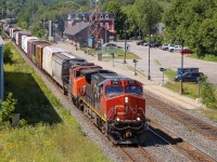 CN Dash 9-44CW 2691 and GP38-2(W) 4809 lead an eastbound through Brockville on August 9, 2015. ES44DC 2277 was the mid-train DPU.