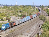 The Oakville subdivision was once home to countless industries and freight trains working the line. Today very few freight trains traverse the line east of Burlington West. Luckily during the daylight hours one can still catch the Clarkson local and a few transfer jobs between Oakville and Aldershot. The view off of the shared GO/VIA parking garage is one of the best along the line and illustrates how a number of one time rail served customers have long since vanished. The opening to the left once housed a rail served customer and CN for a brief period kept a pair of SW1200's here. Just to the right of the signal was a rail served lumber yard, which also housed former CP C630 4500 for a while before it headed off States side. Today the Ford assembly plant in the distance is one of the main sources of traffic for the line, along with an industrial area in Mimico. Here an Aldershot transfer job is seen departing Oakville yard for Aldershot, while a GO train disappears in the background.