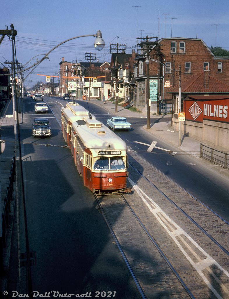 The same photographer who shot this photo of CP 7026 crossing the former TG&B "Old Bruce" service track over Bloor Street, was also shooting streetcars that day in the same spot. They caught this pair of TTC PCC's lead by 4494 MU'ed in Queen service, heading westbound on Bloor Street past Perth Avenue about to duck under the "subway" (common Toronto parlance for an underpass or viaduct before transit subways started being built) under the service track, the CN Weston Sub, and CP Galt Sub mainlines. After ducking under the rail corridor and climbing the grade to Dundas, the cars would continue west for Jane Loop. The local Milnes coal & fuel oil dealer is visible at the southwest corner of Bloor & Perth.

PCC cars serving the busy Bloor and Danforth streetcar lines were often MU'ed together to handle the larger passenger loads, and certain classes of cars were equipped with front and rear couplers for such operations. Once the crosstown Bloor-Danforth subway line opened between Keele and Woodbine in February 1966, streetcar operations ended on that stretch of Bloor, and the Bloor and Danforth "shuttle" runs at both ends that ran until the extensions to Islington and Warden opened in May 1968 were able to get by with single cars. MU'ed PCC operation continued on busier routes such as Queen however.

Original photographer unknown, Dan Dell'Unto collection slide.
