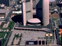September 1st 1921 to September 1st 2021 marks 100 years of the TTC serving the City of Toronto! Here we have a fine photo by Robert McMann taken in September 1967 showing part of the downtown Toronto core, with the then-"new" City Hall (opened 1963) and Nathan Phillips Square in the middle. Along the bottom of the image is Queen Street, with TTC PCC 4695 heading eastbound on the Queen route. Westbound, a TTC GM New Look (or "fishbowl") bus passes two coaches parked on the north side, followed by one of the TTC's 1950-series of Can-Car buses equipped with sight-seer windows cut into the roof. Across the middle of the image is Dundas Street, and to the left one can see a PCC between buildings heading east on Dundas at Elizabeth. On the far right, another PCC turns from northbound Bay to westbound Dundas, likely having come from City Hall Loop (Louisa-James-Albert-Bay) on the Dundas route. Two more GM fishbowls wait northbound and southbound on the 6 Bay route. Across the top of the image is College Street, and Queen's Park is just visible in the upper left, decked out in blue for Canada's Centennial 1867-1967 celebrations.
<br><br>
<i>Robert D. McMann photo, Dan Dell'Unto collection slide</i>.
