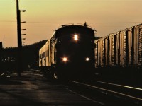 VIA train 676 arrives in Capreol, Ontario at sunset on April 17, 1987.  With classification lights displaying white, the train is operating as an extra.  It appears that either the crew or passengers or both can't wait to get off the train.