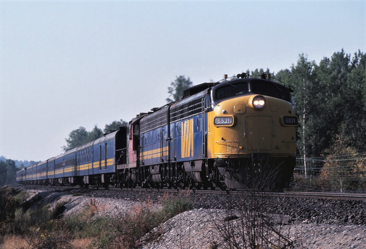 Forty years ago VIA's Super Continental Train #3 approaches Milnet, Ontario on August 1st, 1981.  Power for the train is FP9A 6531, F9B 6617, and CN GP9 4105.