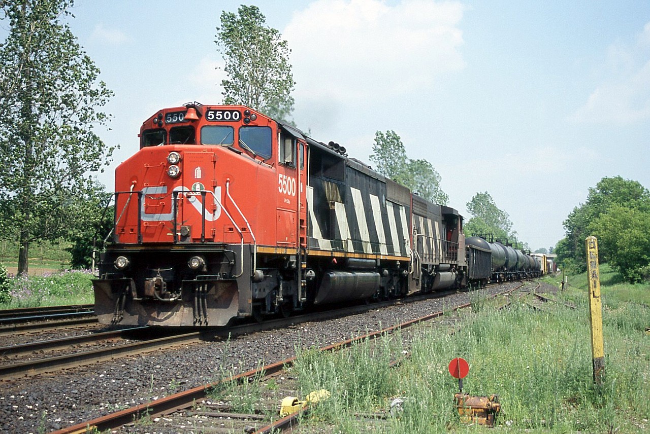 CN SD50AF 5500 and a matching zebra-stripped SD40-2W grind up hill through Copetown, ON. It's hard to believe this was taken 17 years ago.  CN 5500 was sold to the Dakota, Missouri Valley & Western and continues in service for them with many other CN cast-offs, including several SD50F, SD50AF and SD60F.