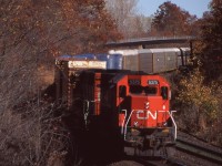 With autumn almost upon us, this scene seemed fitting. It was Halloween day 1998 and the shot at Bayview was much different back then, as a CN former UP/MP SD40 and CN GP40 round the bend at Bayview under fading fall colours with a Niagara bound train. 