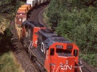 During the 1990's CN was at a point where it needed to figure out what to do with its old straight SD40 fleet, either rebuild or retire. In the end a group of 29 units were rebuilt and classified as SD40U's. As for the rest they were gradually retired and most found an extended career elsewhere, many leased back to CN as part of Alstom's GCFX lease fleet. CN decided at the time it was more cost affective to look at the secondhand market for the rest of its SD40 needs, and purchased a group of former UP/MP SD40-2's to fill the void. This day CN SD40-2 5375, ex CN 6096, exx UP 4096, exxx MP 3096, nee Mo-Pac 796 is assisted by one of CN's SD40U's as they lead intermodal train 149 or 143 westward at Bayview.