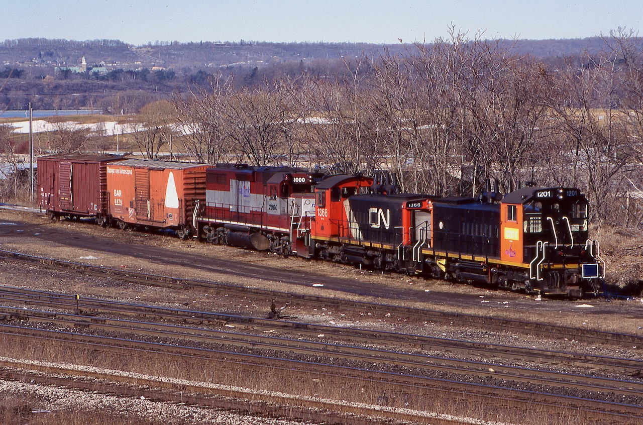 In Valentine's Day 1998 the former CN yard in Hamilton certainly had a different look to it. Railink was the new kid in town with an interesting mix of motive power. The 1200 was an older former CN SW1200, while 1366 was being bored from CN until enough power was on hand to properly run Hamilton operations. The 2000 was a former Maine Central GP38 that made it to the New Hampshire & Vermont Railroad, sadly that interesting shortline was forced to shut down and Railing picked up the unit. In later years 2000 would move out west to one of Railink's western operations, while out there it would receive full Railink paint and later return to Hamilton. It has since received full G&W colours and still calls Southern Ontario home. Today CN has taken back all Hamilton operations from G&W.