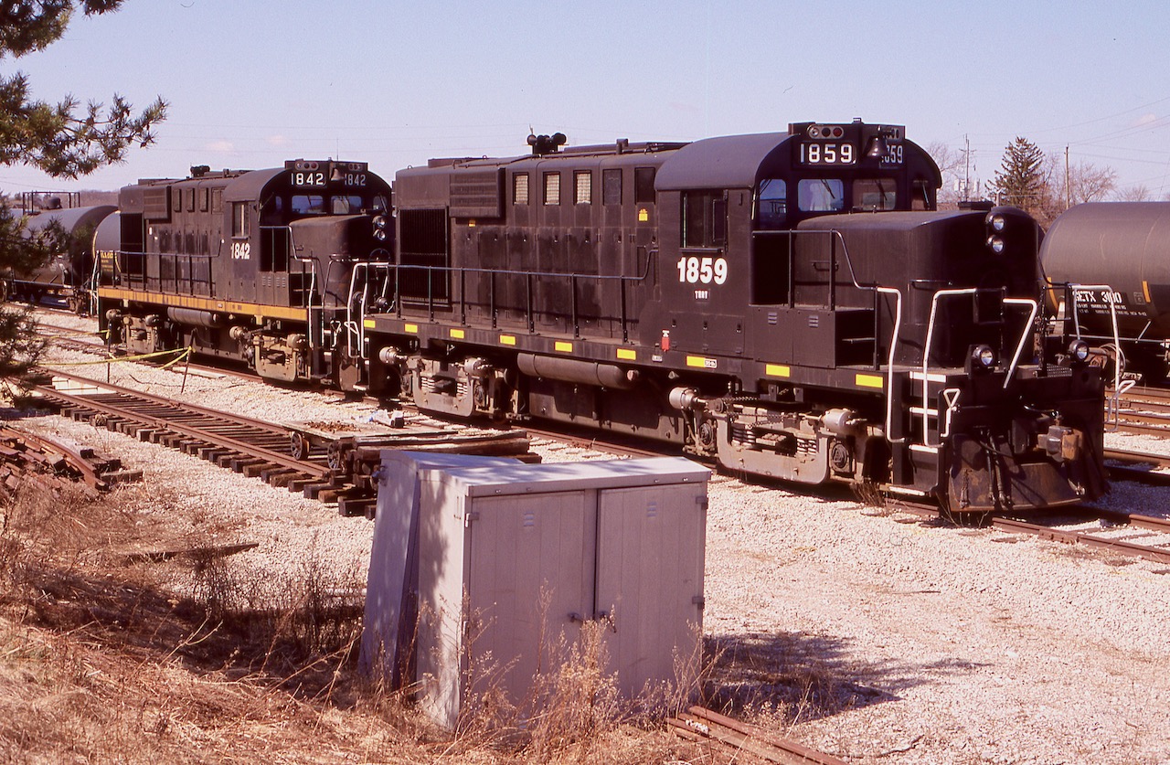 By the late 2000's Trillium was going through a number of changes, and its recent termination of its partnership with The New York & Lake Erie RR left Trillium a bit short of motive power, considering NY&LE reclaimed a few of the units operating on Trillium properties. As luck would have it CN's recent takeover of the Ottawa Central as well as New Brunswick East Coast, left them with a decent size fleet of unwanted MLW built units such as RS-18's and C424's. Trillium soon picked up a pair of ex OC Rs-18's in the form of 1859 and 1842, both originally CP units. The 1842 is unique as CP rebuilt it using components from both a CP RS-18 as well as the long hood from a retired CN RS-18, which explains the odd air intake behind the cab. the pair are seen in Tillsonburg yard not long after their arrival. It is interesting that Trillium was busy at the time rebuilding some rail on the south side of the yard back then considering they were originally ripped out not long after Trillium took over the yard. Today The Cayuga sub. is in sad shape basically on the brink of abandonment with no train traffic in well over a year. This past summer the rails were lifted between Delhi and Courtland and the rest of the line may soon join it. The yard here too is weed choked and silent. For now the two RS-18's are still employed by Trillium's new owner but only 1859 is in service
