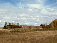 Westward from Grande Prairie, AB, the Northern Alberta Railways line to Dawson Creek, BC, travelled through numerous small communities, the first being Dimsdale, and this view is a few miles east of there at mileage 54.8, providing an ideal picturesque prairie branchline scene with good lighting for the Monday, Wednesday, Friday passage of train No. 51 westward from Grande Prairie, seen here with GP9 206 on Wednesday 1977-09-21, just a normal day in the paradise that is the Peace River region in autumn.  A single GP9 running short-nose-leading was always a magnet for me and my cameras.