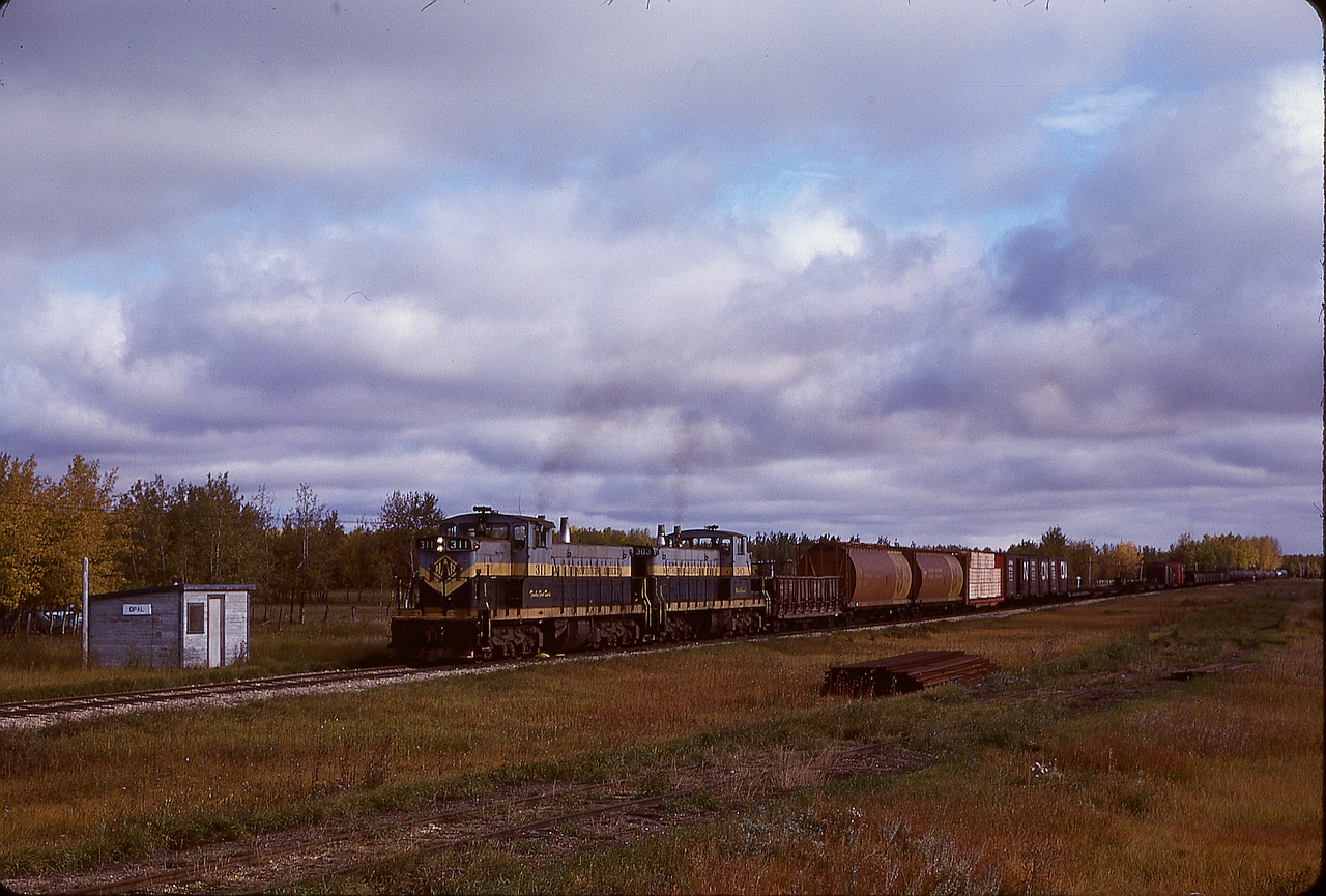Now lost to history as this stretch of track was abandoned in 1986, the hamlet of Opal (between Carbondale and Kerensky) was at mile 23.5 on NAR’s Lac La Biche sub., and on Wednesday 1980-09-24 saw the passage of GMD1s 311 and 303 on a Mixed Extra South which left Waterways in Fort McMurray the previous morning with an overnight at Lac La Biche.