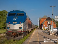 On time in Ontario. Amtrak 63 (Maple Leaf)/ VIA Rail Canada 98 makes the extended station stop for customs and crew change in Niagara Falls, Ontario on the evening of Tuesday, August 28, 2018. Golden hour is just beginning as the train sits next to the station. The depot is a historic treasure, built in Victorian Gothic Revival style station for Great Western Railway in 1879.