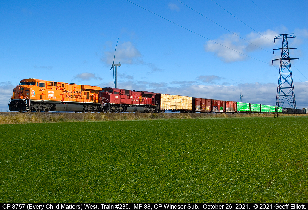 CP Train #235 makes good time as it nears the Rochester Townline Crossing just east of St. Joachim, Ontario on October 26, 2021.  Today's leader is CP 8757, the "Every Child Matters" unit, which looks stunning in it's orange livery, stands out against the blue sky and new winter wheat in the Fall sunlight....
