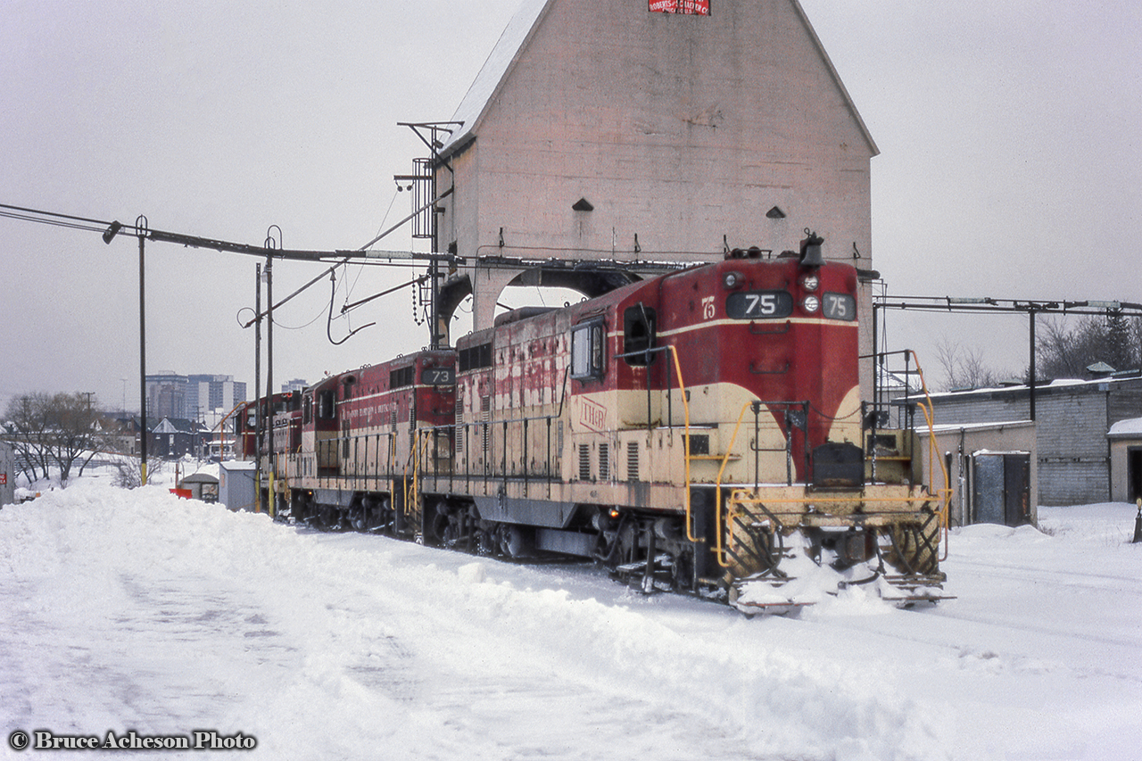 TH&B GP7s 75 and 73 along with a 50-series NW2 or SW7 rest near the Robertson & Schaefer (note red sign) engineered sand tower at Chatham Street.