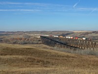 A winter chill is in the air, as Vancouver to Toronto Q 10251 11 rolls through the Battle River valley and over the impressive trestle.