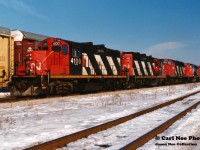 Currently CN 4100 is awaiting a date with K&K’s scrapper’s torch in Welland, Ontario at the former Martech / former Stelpipe facility. Over 26 years earlier it is seen on the point of CN 511 at London about to head westbound to Sarnia on a decent winter day. The consist included; 4100, 4115, 9608, 9569, 9454 and Burlington Northern 9526. At that time, CN was lifting hundreds of newly built BN SD70’s from the GMDD facility in London and forwarding them to BN home rails at Chicago, Illinois. 