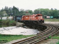 Back when cheeseburgers were 89 cents, the CP Galt day job slowly crosses the Speed River in Preston, Ontario on the Waterloo Subdivision with 1508, 8247 and HLCX 4203 during spring 1998. The hoppers on the head-end were destined for the interchange with CN at South Junction in Kitchener.
