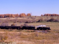 Ontario Rail Association's former CPR 136 and 1057 duo, now lettered for the Credit Valley Railway, operate on a fall ORA fantrip over the Canadian Pacific's Orangeville and Owen Sound Subs during October 4th & 5th, 1975. They are seen here doing a run-by along the fall countryside at what I believe to be Mile 42 of the Owen Sound Sub, between Markdale & Flesherton (where exactly I haven't been able to pin down). Both were part of the famed CPR Tripleheader in May 1960, and went on to many fantrips and excursions in the 1970's under Ontario Rail ownership.<br><br>The late 80's spelled the end of the Owen Sound Sub between Orangeville and Owen Sound, while the section between Orangeville and Streetsville Junction (owned by the Town of Orangeville since 2000) could be facing the same fate by the end of 2021.<br><br><i>Original photographer unknown, Dan Dell'Unto collection slide.</i>