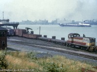 CPR SW8 6702 (GMD, 1950) with its pair of idler flats, pulls a cut of cars - including an L&N "DIXIE LINES" gondola - off of the Wabash Railroad car float, <i>Windsor,</i> onto Canadian soil.  Built in 1930, the <i>Windsor</i> would continue in service under the Norfolk & Western Railroad and Norfolk Southern.  It was reportedly scrapped in 2007.

<br><br>6702 would be retired in 1990 and sold to the D&H (CP-owned) in 1992.  Retiring in 1999, it would go to Larry's Truck and Electric 900, and leased to WCI Steel of Warren, Ohio in as their WCIX 831.  That plant has since closed (circa 2013) and the unit reportedly returned to Larry's.  Further history unknown. 

<br><br><i>Original Photographer Unknown, Al Chione Duplicate, Jacob Patterson Collection Slide.</i>