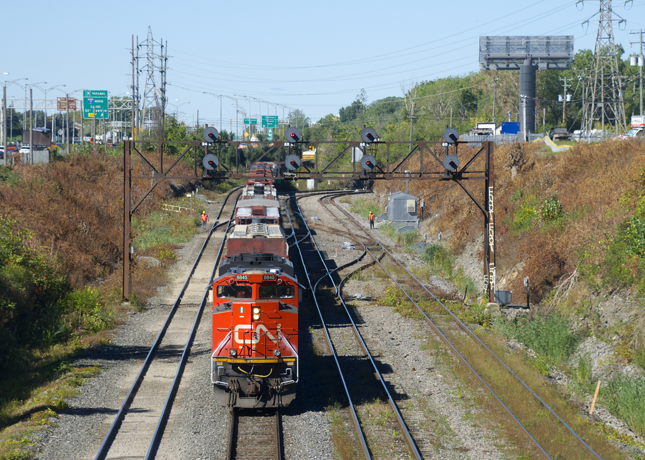 After spending much of the night parked about a half mile west of here, CN 306 is on the move with CN 8845 up front and BCOL 4648 mid-train. Carmen are visible on either side of the train in the distance and they would find a problem with the fourth car. The train would come to a stop a few seconds later and the carmen did some quick work on the problematic car before CN 306 was able to depart about 10 minutes later.