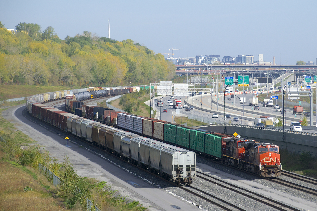 CN 305 has lumber and aluminum up front as it approaches the crew change spot of Turcot Ouest with CN 2280 & CN 2648 for power.