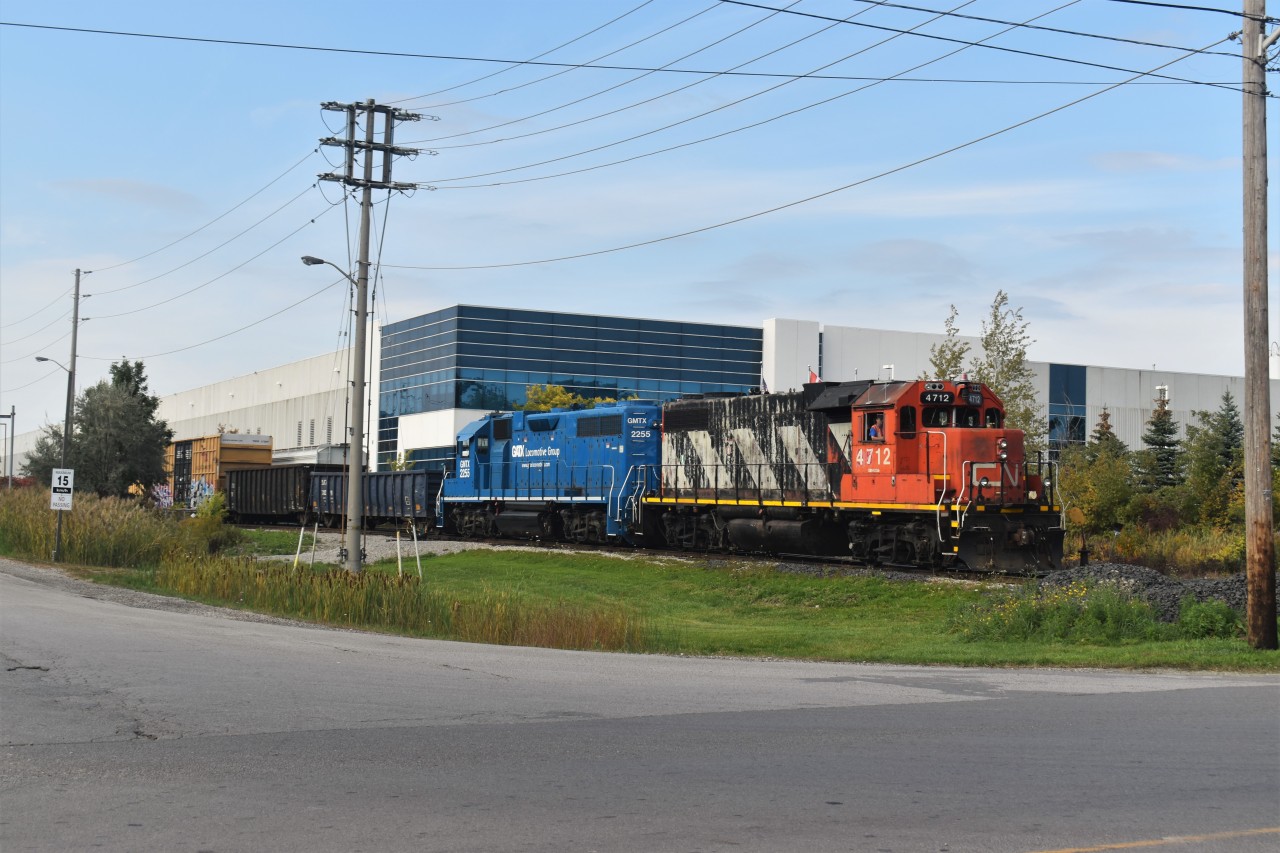 CN L551 with CN 4712 and GMTX 2255 shoves cars past one of the small spurs off of the Halton Sub in Milton (Glass Lead) located near Milbase. This day they would have delivery and Pickup with Frame cars from Modatek and Gondolas from Karmax before continuing past mansewood to work some other industires.
