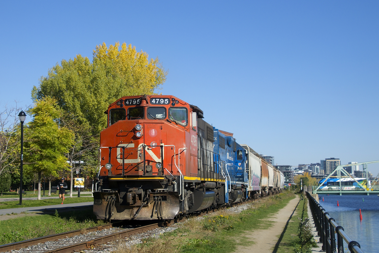 The Pointe St-Charles Switcher is heading east along the Lachine Canal as it shoves grain cars towards Ardent Mills.