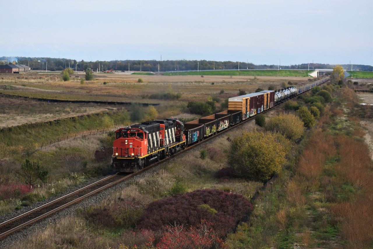 CN L551 with GP402 9547 and GP9RM 4138 head northbound (eastbound) through CN Ash in Milton bound for the industrial area including the Glass lead and other industries along the Halton sub for pickup and drop-off.
