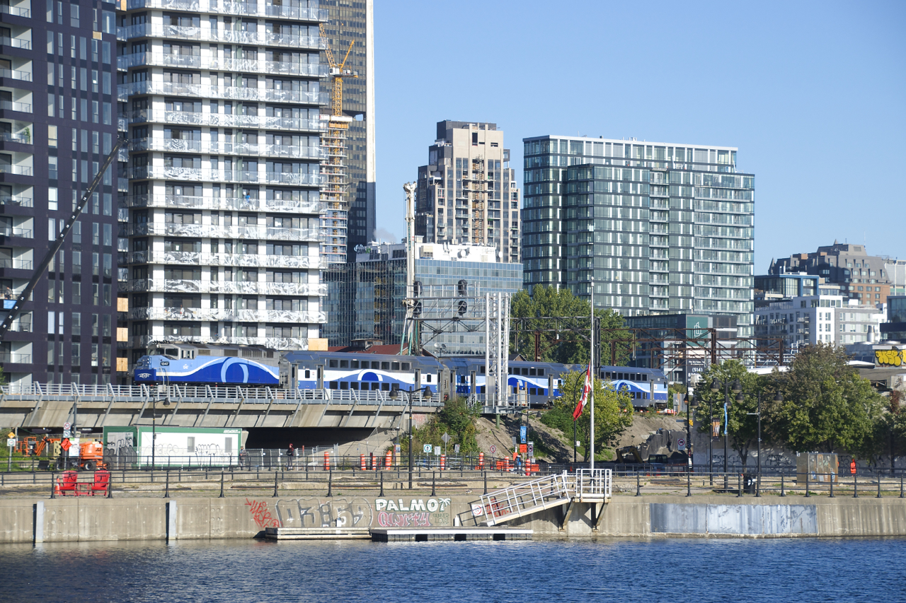 The last inbound train of the morning from Mascouche is passing a not yet active signal gantry with AMT 1347 pushing three multilevel cars.