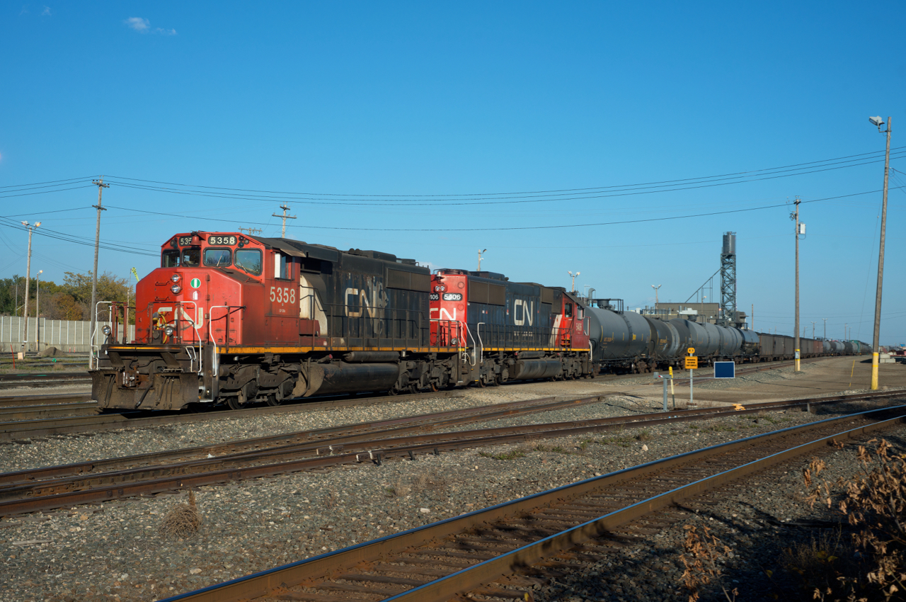 Modern day yard power works the west end of Walker Yard in Edmonton.  Beltpack equipped SD60 CN 5406 is the controlling unit with SD40-2W CN 5358 assisting.