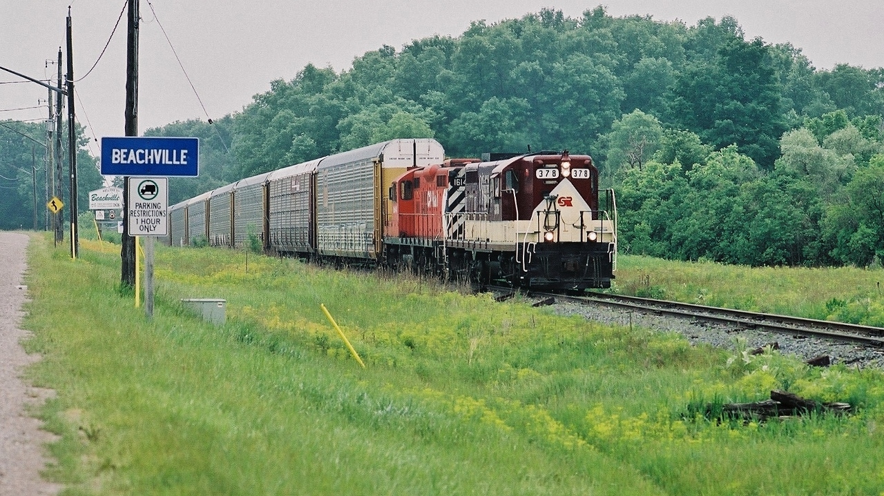 EMD 1951 built GP7  #378 ( ex Soo 378, nee MStP&SSM 378) 


   and  remanufactured 1986  GP9u  CP Rail  #1614 * ( ex CP Rail 1959 built GP9 #8823 ) on loan to to OSR, 


   power an OSR transfer hauling  a string of trilevels loaded with 2010 Chevrolet Equinoxes....


   at Beachville Ontario, June 16, 2010 FujiFilm Superia negative by S.Danko   


    *  CP Rail #1614 retired March 2012 and traded in to EMD (one of many GP9u) for the GP20C-ECO 2200 series units