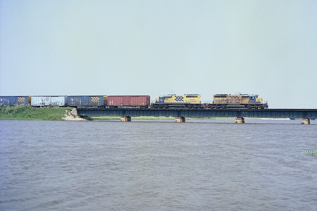 The paint on ONR 1733 and 1734 looks rather tired on these units leading an eastbound train over the Frederickhouse River. This movement is returning to Englehart from the Kidd Mine area. The line used to go as far as Timmins, but no more. It has been over 20 years since this image. Interesting the CTG states both SD40-2 locos are still working for the ONR.