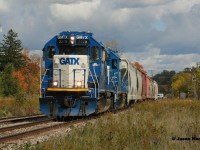 Two blue GMTX's catch a gift sunny break amongst the clouds and a splash of fall colors during my birthday last year as they lead CN L568 through Baden westbound on the Guelph Subdivision.