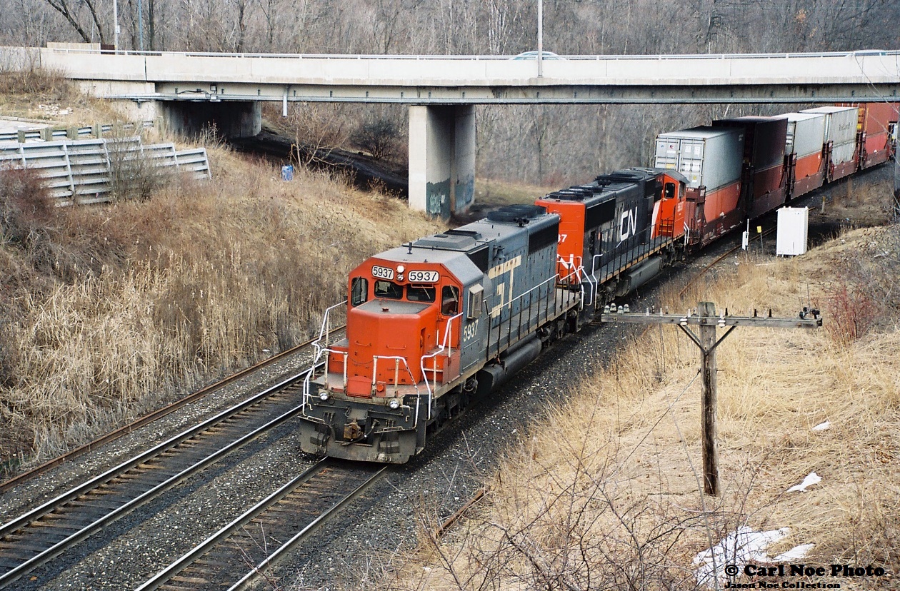As the last remnants of winter are slowly fading to an early spring, GTW SD40-2 5937 leads a westbound, likely 149, through Bayview Junction with its ditch-lights off, indicating a rolling meet with an impending eastbound.  

GTW 5937 was one of the last SD40-2’s to survive in its blue GT colors, having been built as Missouri Pacific 3196 in March 1975 then later becoming Union Pacific 4196 and adorned in amour yellow. Surprisingly today this unit still soldier’s on CN and was even repainted in the latest CN paint scheme during likely 2012 after surviving a lengthy stint in the Homewood, Illinois deadline in Chicago.