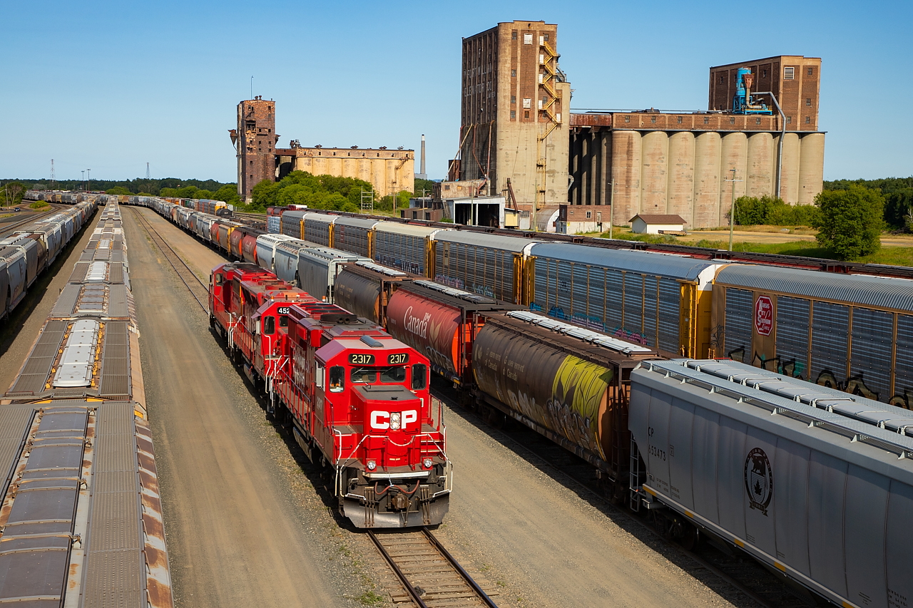 CP 2317 leads for the 1559 Yard Job (conventional crew) as they pass through CP's yard in West Fort. Grain terminals of years past provide the backdrop.