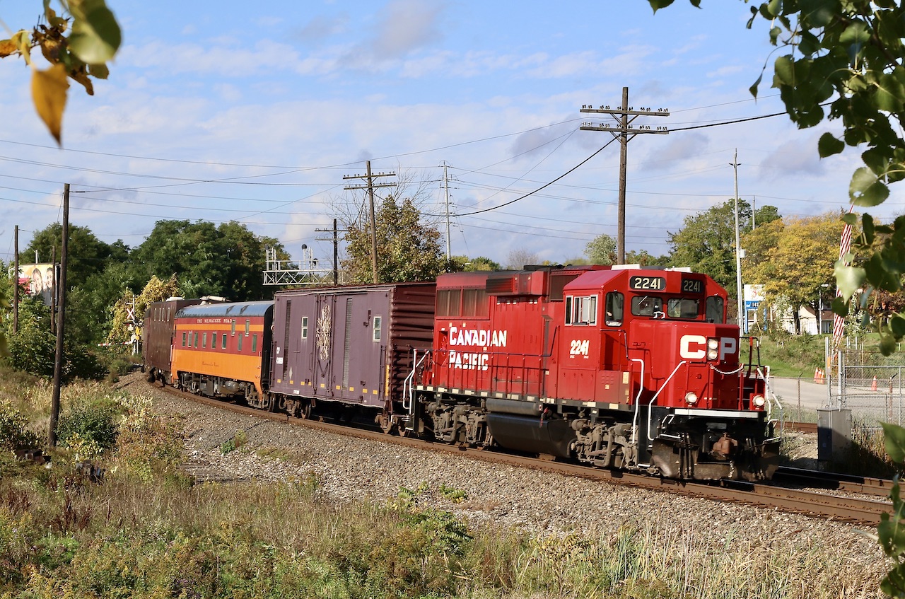 CP TEC train led by GP20ECO 2241 crosses Mississauga Road in Streetsville with a borrowed "Milwaukee Road" coach in the consist. The train is seen traveling from Hamilton to Toronto.