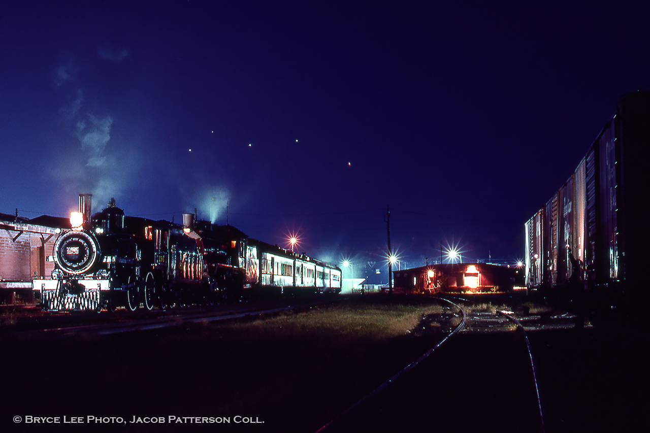 A hissing emanates from within the Owen Sound CPR yard as wisps of steam rise into the crisp air off of Georgian Bay.  The late evening during Thanksgiving weekend in October 1974 finds a pair of steam locomotives resting during a Toronto - Owen Sound and return fan trip run by Ontario Rail.  In the morning, the engines will be serviced, turned, and will depart on their return run with a stop at Chatsworth for a runpast.  Continuing south, the trip will take a pause around Markdale due to an issue with poor quality coal, delaying the trip for an arrival 11 hours late.

Bryce Lee Photo, Jacob Patterson Collection Slide.