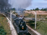 Operating on a Toronto - Niagara Falls UCRS excursion, CNR 6218 ducks under the tell tales approaching Portage Road on the outskirts of Niagara Falls.<br><br><i>Ken B. McCutcheon Photo, Jacob Patterson Collection Slide.</i>