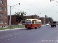 TTC 4269 (an air-electric A4-class PCC built in 1944) heads westbound on Dundas Street East on the lengthy Harbord route (bound for Lansdowne Loop) passing by apartment buildings of the famed Regent Park neighbourhood, at Regent Street east of Parliament Street. Visible in the background is part of the Sts Cyril & Methody Macedonian-Bulgarian Eastern Orthodox Church at Dundas & Sackville, built in 1948 and still present today. I've never seen too many transit photos taken along this stretch, likely because this wasn't the most picturesque part of the city by any stretch, and in later years Regent Park gained a less-than stellar reputation.<br><br>Regent Park was a post-war affordable housing project by the government, Canada's largest public housing project at the time. A run-down area to the east of downtown Toronto off Parliament Street (historically considered a slum home to the poor, working class and new immigrants) was razed for new affordable housing apartment complexes and public housing starting in the late 40's, with redevelopment continuing until 1960. Matters seemed to get worse over time, with crime, gangs, poverty, poor living conditions and social problems in the area continuing or taking hold over the decades. Criticisms of the original plan include having much of the area as residential housing only (instead of mixed work-residential-commercial use), much of the design being utilitarian and bland with no frills (not a very aesthetic place to live or visit), and urban planning policies at the time proving to be detrimental (replacing many of the former public streets with sidewalk networks in the new development, creating an inward-focused environment).<br><br>Eventually plans for public-private redevelopment and gentrification of Regent Park, including demolishing and replacing the aging apartment buildings, were introduced in the 2000's. Included were plans for a certain amount of affordable housing, i.e. having a mixed social-economic demographic of residents (although some argue it unintentionally forces long-time lower-income residents out through local gentrification and increased property values, but that's another story).<br><br>As with most of the TTC's older air-electric PCC's, 4269 was stored following the opening of the new Bloor-Danforth subway line in February 1966, which rendered part of the (older) streetcar fleet surplus. Its disposition is unknown, but photos show it did end up in the <a href=http://www.railpictures.ca/?attachment_id=39755><b>Hillcrest PCC deadline</b></a>, so was likely cut up for scrap there in the late 60's with some other unsold cars. Some luckier sister cars were noted as being sold to Alexandria, Egypt.<br><br><i>Robert D. McMann photo, Dan Dell'Unto collection slide.</i>