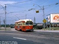 Pulling out of the old Keele Loop, TTC PCC 4514 (one of the A8-class PCC cars built by CC&F in 1951, the last new PCC's purchased by the TTC) on the Rt.512 St. Clair enters Weston Road for the shot jaunt to St. Clair, where she will turn and head east bound for the Spadina Line's St. Clair West Subway Station (short turning, as per the front flap turned up). A this time, the old <a href=http://www.railpictures.ca/?attachment_id=34071><b>Keele Loop</b></a> was on borrowed time, with the new <a href=http://www.railpictures.ca/?attachment_id=45395><b>Maybank (Gunns) Loop</b></a> further west on St. Clair opening a year later. Advertising billboards push Rothman's Special Mild cigarettes, and Kentucky Fried Chicken featuring Colonel Sanders (who apparently lived in nearby suburban Mississauga in his final years). <br><br> In the background are CN's old West Toronto freight yards, for years often full of livestock cars and <a href=http://www.railpictures.ca/?attachment_id=33806><b>reefers</b></a> to serve the nearby meat packing industry. As time went on and a lot of that industry closed up or moved out, the yards fell out of use in the late 80's and were removed. The empty land was eventually redeveloped into townhouses in the early 2000's. <br><br> <i>Joe Testagrose photo, Dan Dell'Unto collection slide.</i>